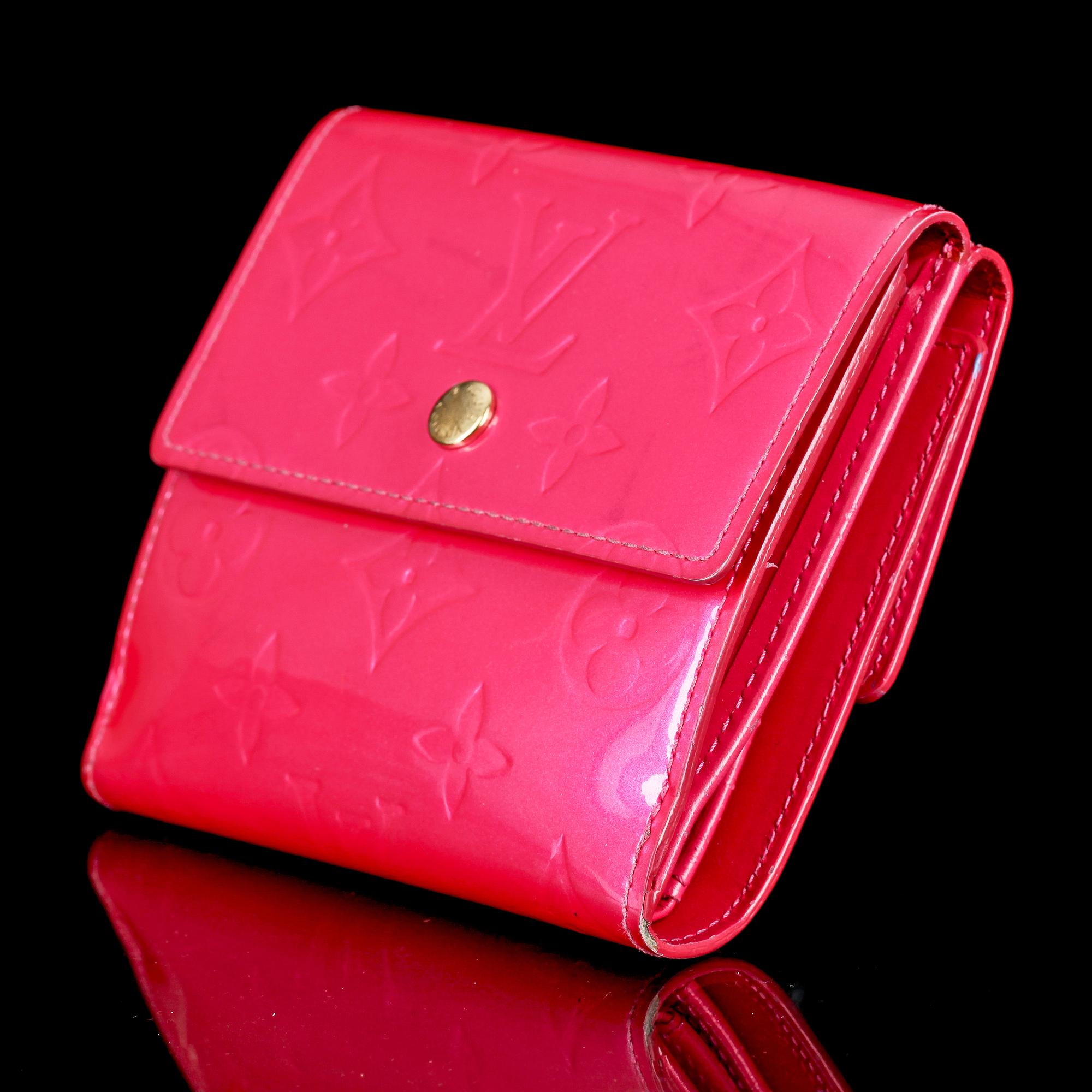 A cerise monogram vernis wallet by Louis Vuitton.