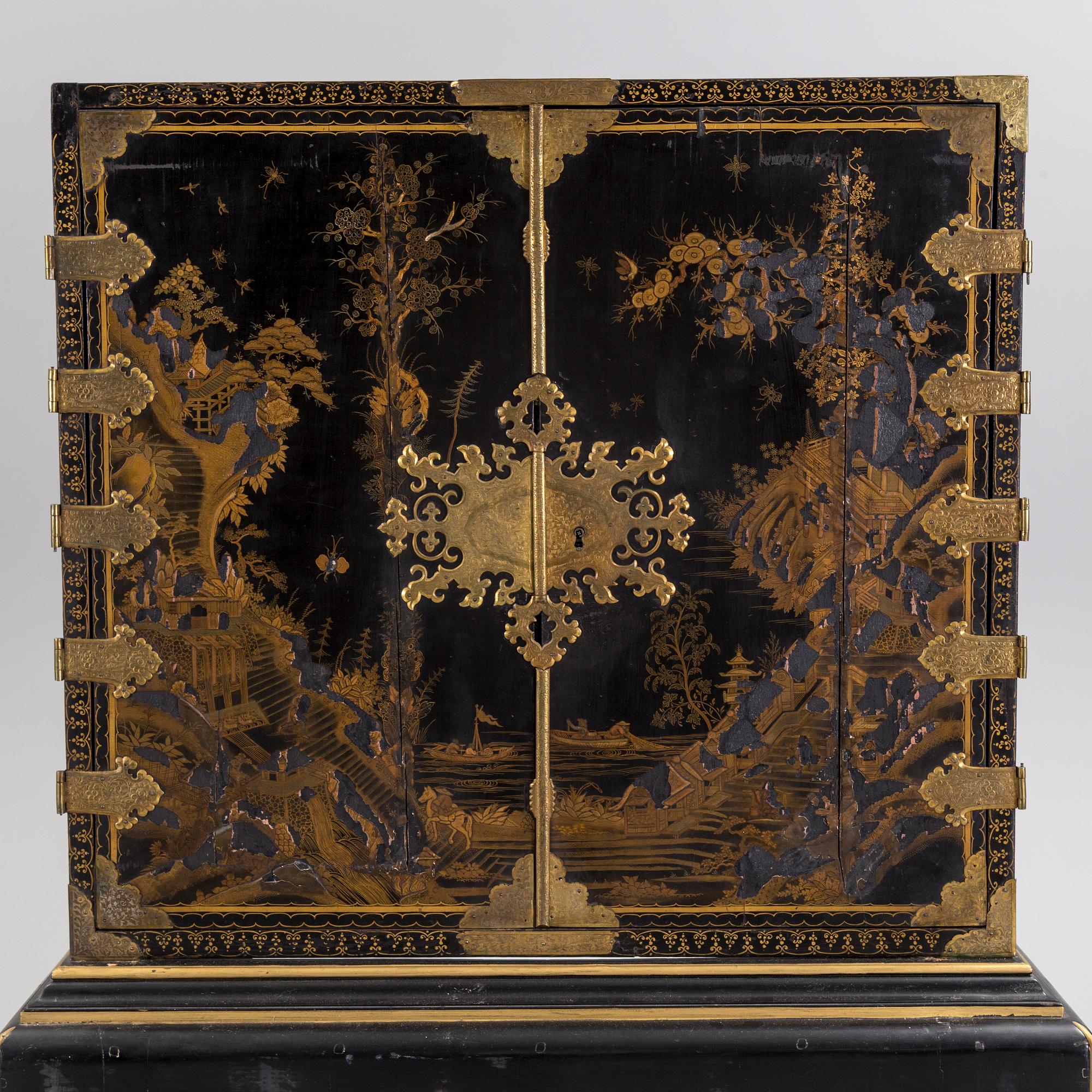 AN early 18TH CENTURY PROBABLY ENGLISH Japanned laquer cabinet on stand.
