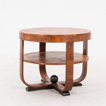 A stained wood table from the first half of the 20th century.