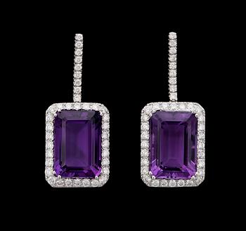 1064. A pair of amethyst and diamond earrings, tot. app 1.40 cts.