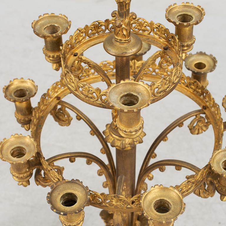 Two similar 19th century bronze candelabras.