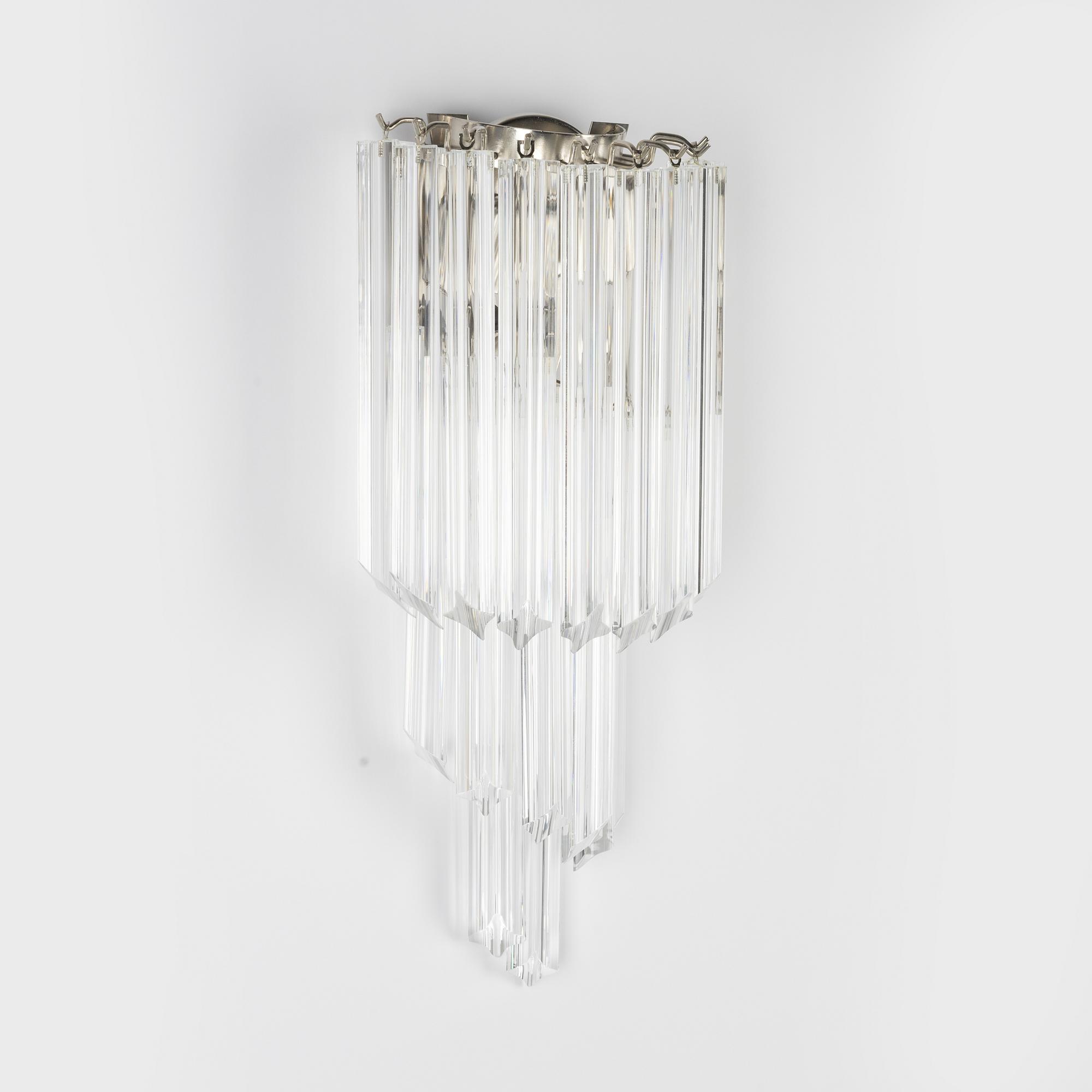 A pair of glass and metal wall lights.