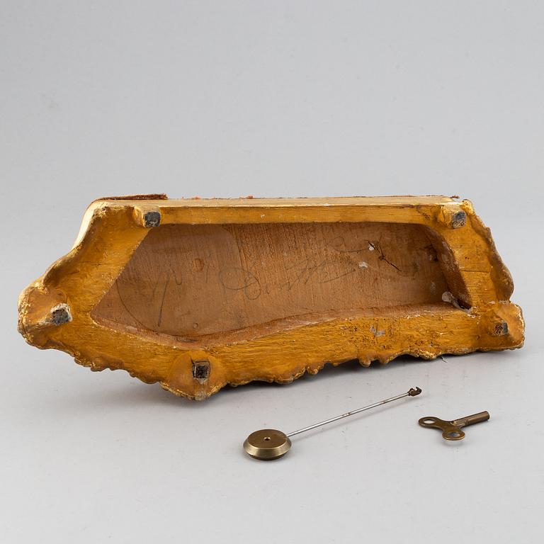 A 19th-century rococo-revival ormolu mantle clock.