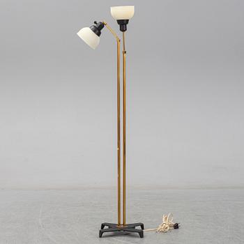 A 1950s brass and glass floor lamp.