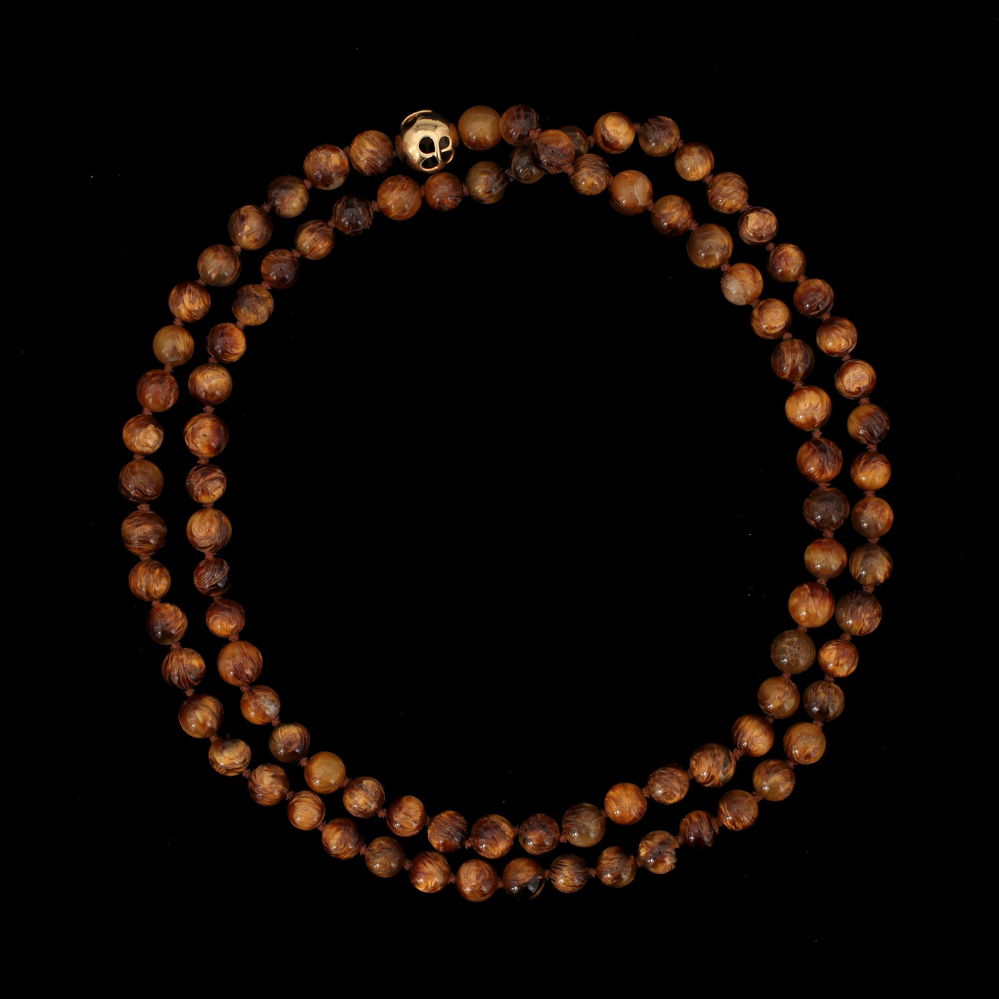 A Tiffany & Co Angela Cummings necklace with tigers eye quartz and gold clasp.