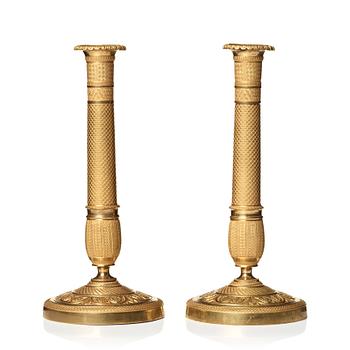 129. A pair of Empire candlesticks.