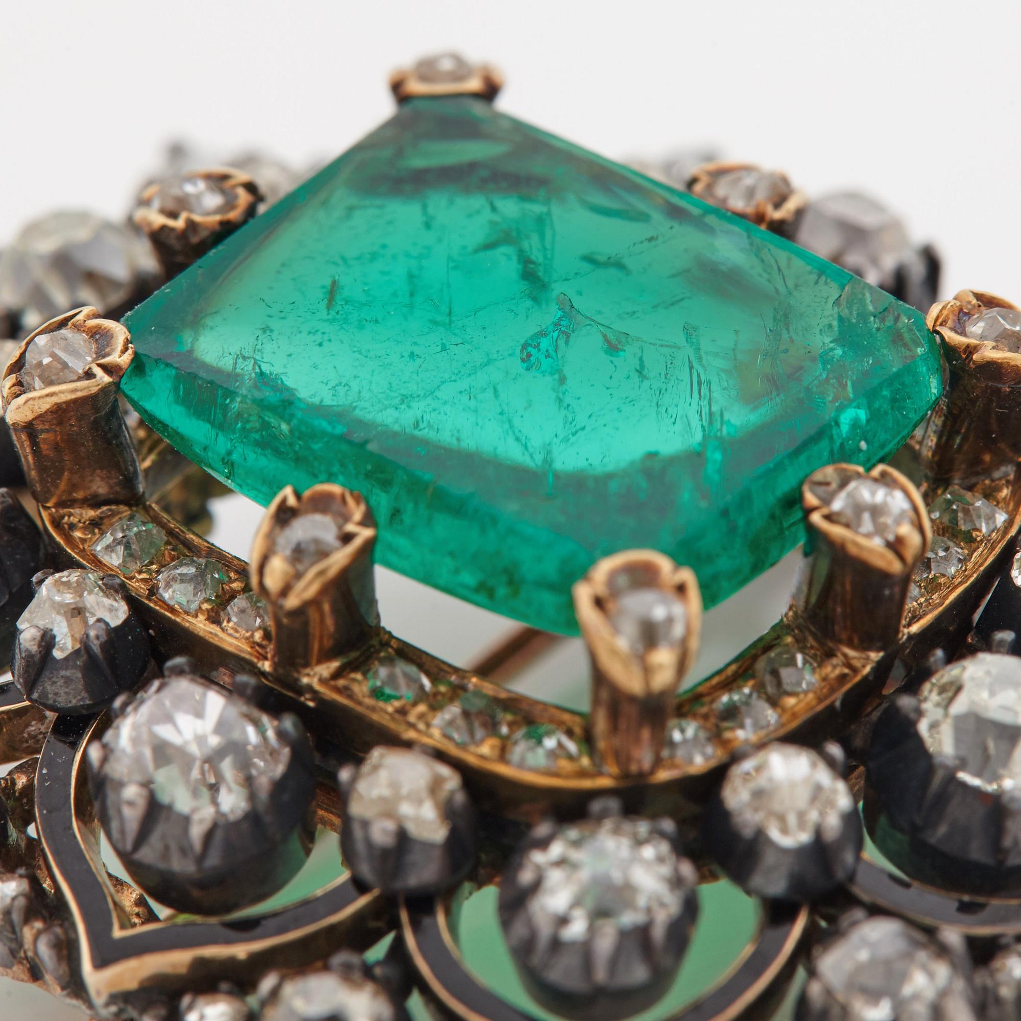 An emerald, black enamel and old cut diamond brooch. 19th century.