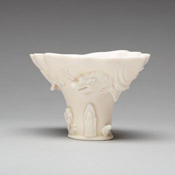 A blanc de chine rhinoserous shaped libation cup, 17th Century.