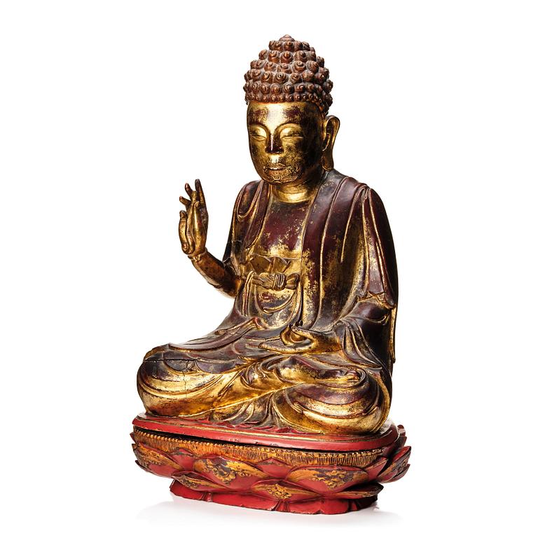 A large gilt and lacquered figure of a seated buddha, Qing dynasty, 19th Century.