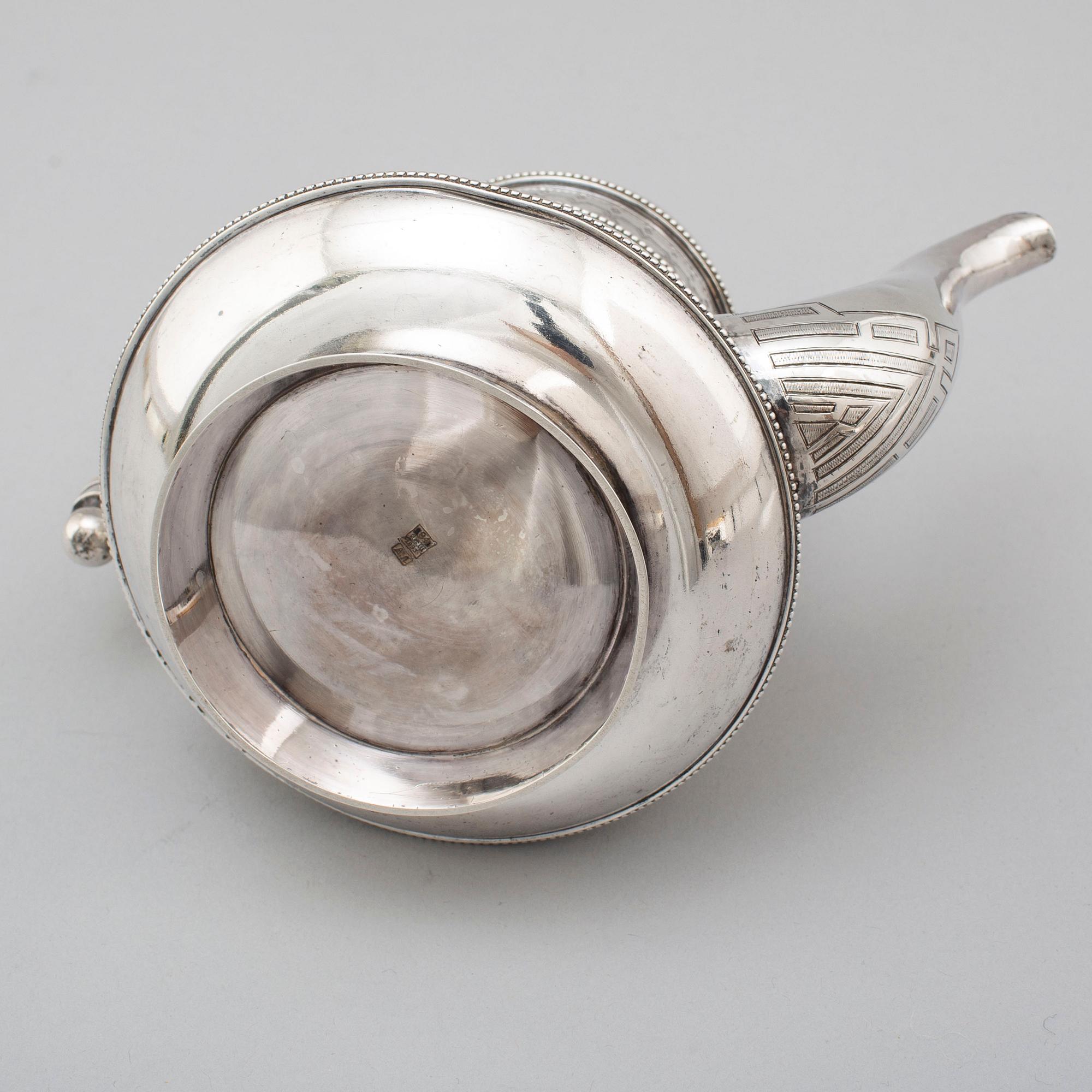 A Russian 19th century parcel-gilt silver tea pot and cream jug, mark possbly of Alexander Lokin, St. Petersburg 1893.