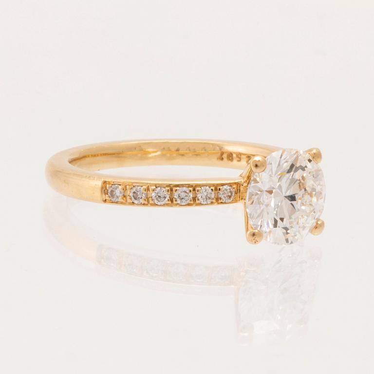 An 18K gold ring set with round brilliant-cut diamonds, GIA report.