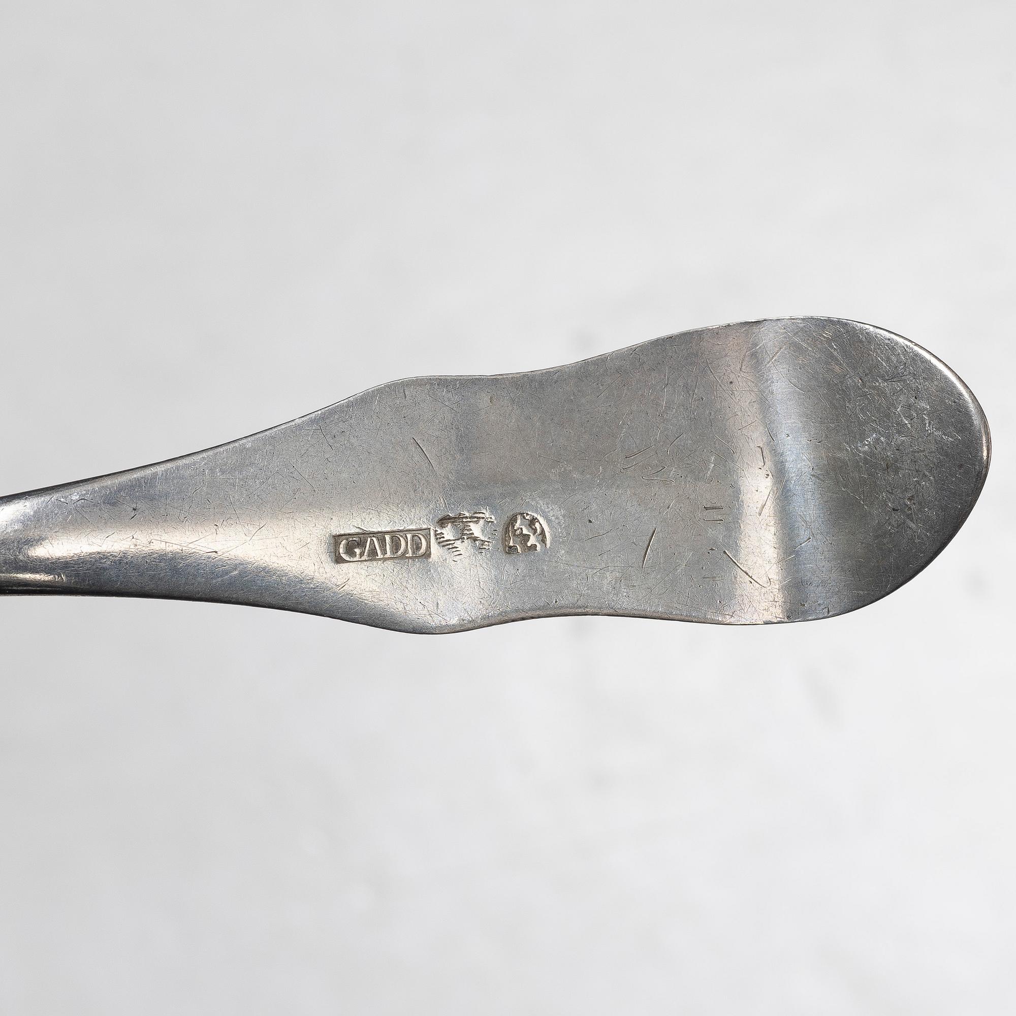 Seven silver spoons, including English and Swedish hallmarks.