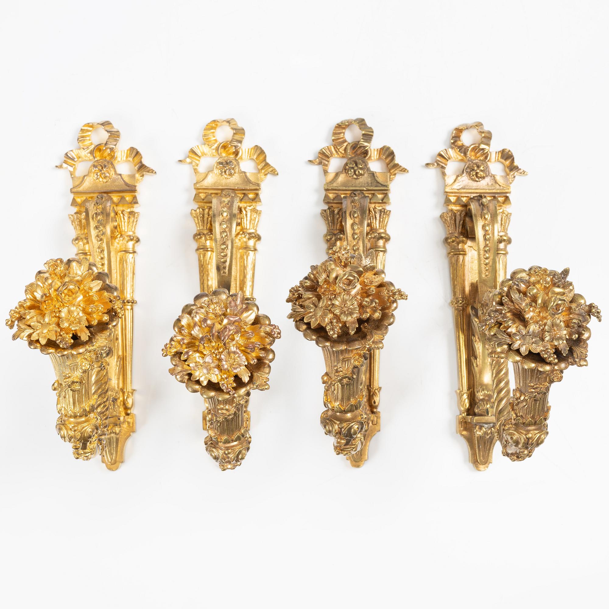 A set of four gilt bronze Louis XVI-style curtain holders, late 19th century.