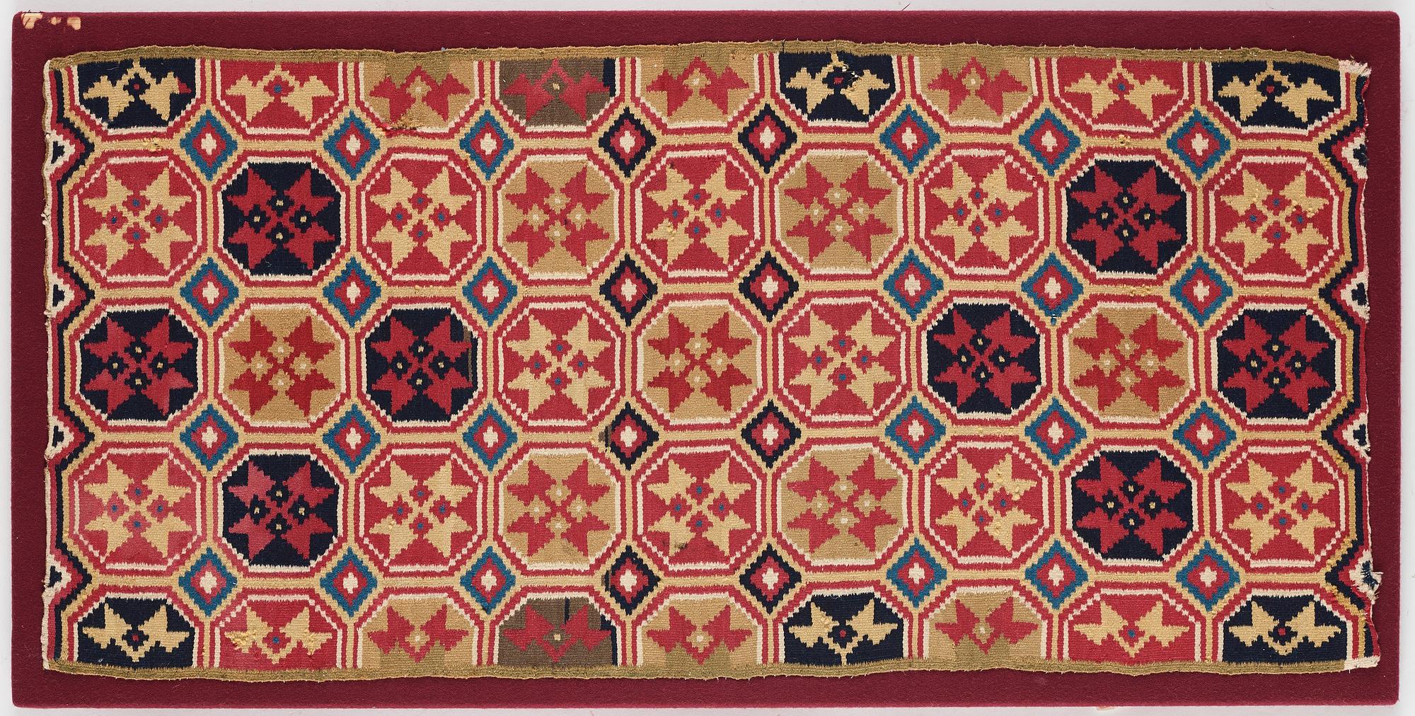 A CARRIAGE CUSHION, double-interlocked tapestry, "Stjärnmönster", ca 43,5-44,5 x 94-95 cm, Scania (Sweden).