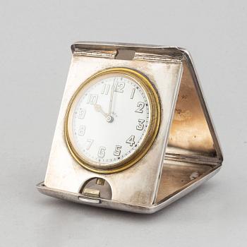 A silver travel alarm clock, makr of Hasset & Harper Ltd, Birmingham 1921.