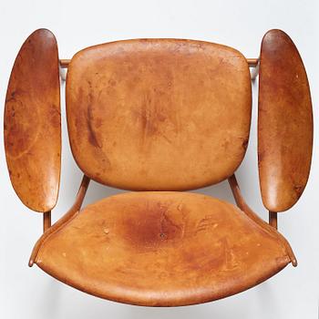 Finn Juhl, a teak and natural brown leather "Chieftain Chair" by Niels Vodder, 1950-60's.