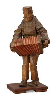 177. Axel Petersson Döderhultarn, Standing accordionist.