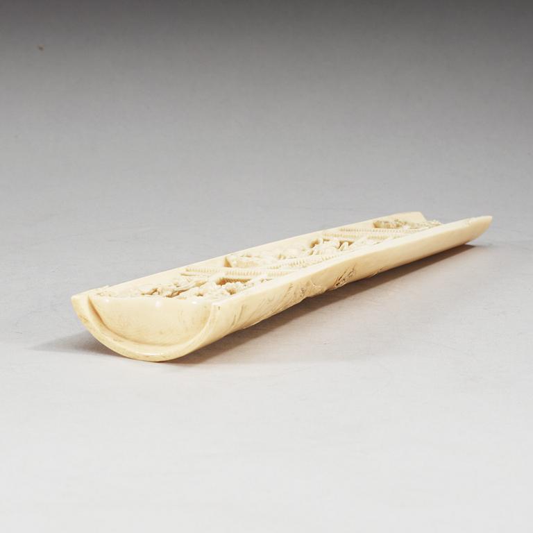 A carved ivory armrest, Qing dynasty.