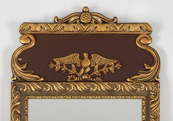 a bronzed mirror and a console table from the second half of the 20th century.
