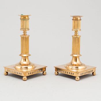 A pair of brass candlesticks, first half of the 20th Century.