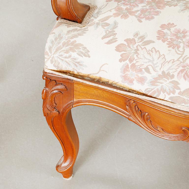 A pair of rococo style arm chairs, early 20th century.