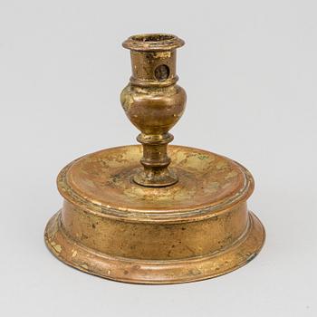 A 17th century bronze candlestick.