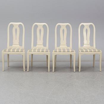 A Carl Malmsten dining table and four chairs. Three leaves included.