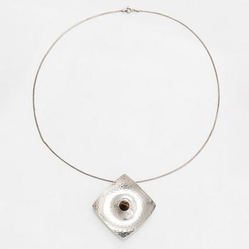Elis Kauppi, a silver brooch/pendant, and tiger's eye. Kupittaan Kulta, Turku 1962.