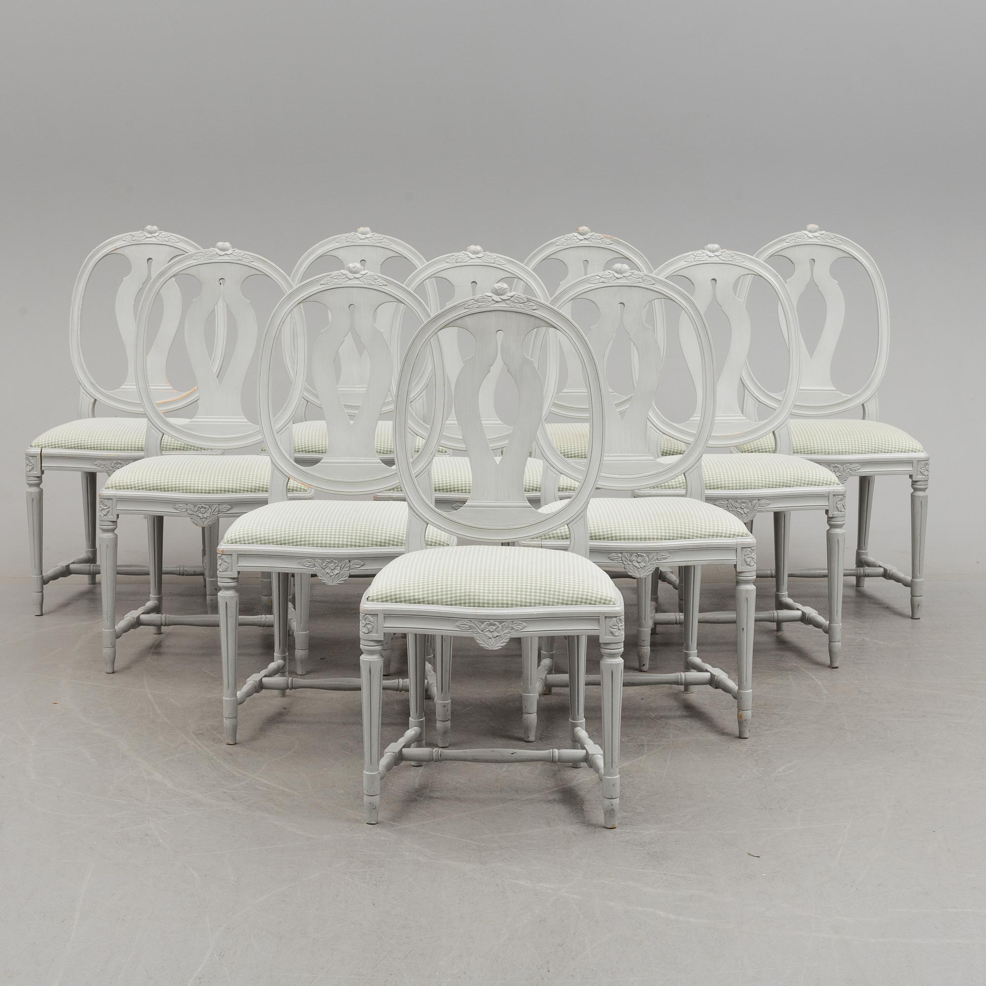 A Gustavian style dining table and ten chairs, 20th century.