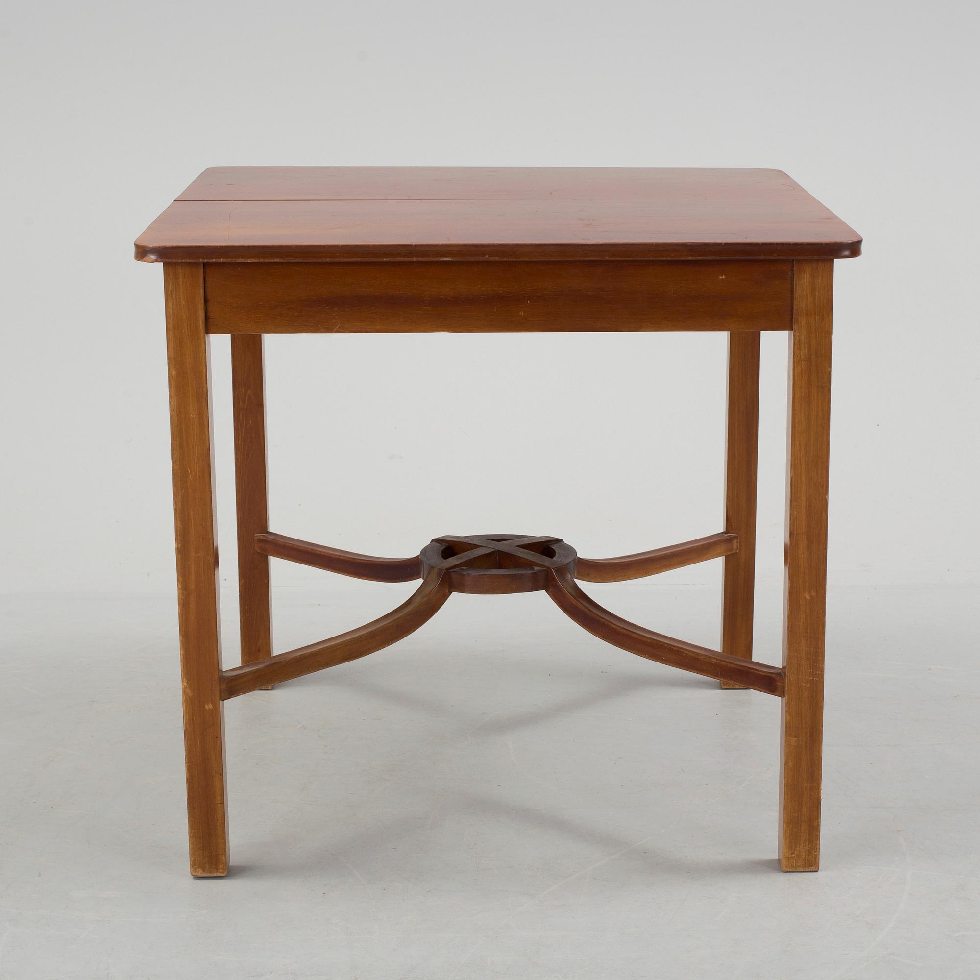 A mid 20th century mahogany veneered table from Nordiska Kompaniet (NK).