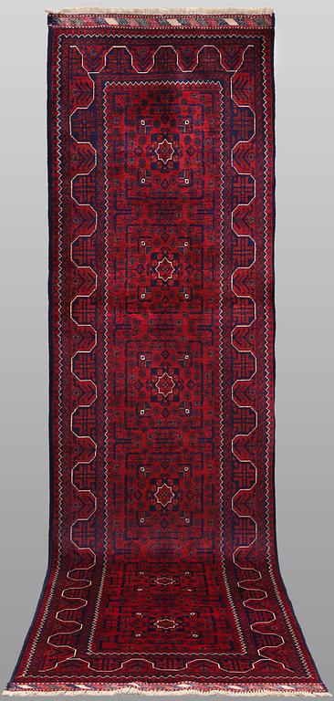 A Afghan runner carpet, 304 x 84 cm.