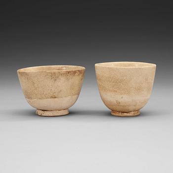 Two white-glazed pottery wine cups, presumably Tang dynasty (618-907).