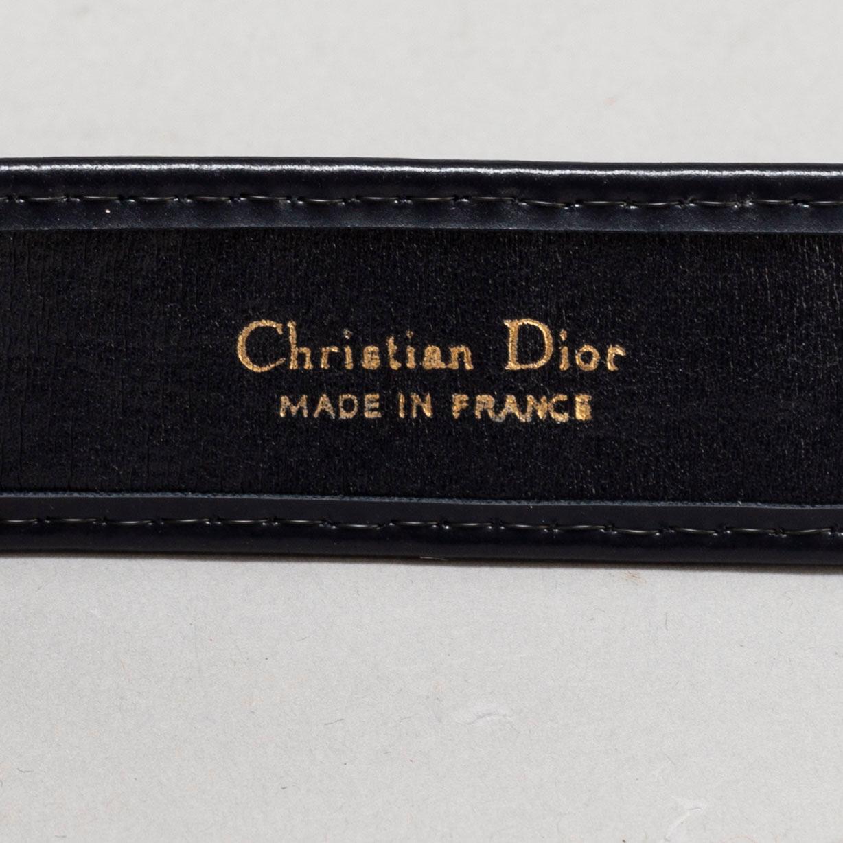 CHRISTIAN DIOR, a set of a clutch, a belt and an umbrella.