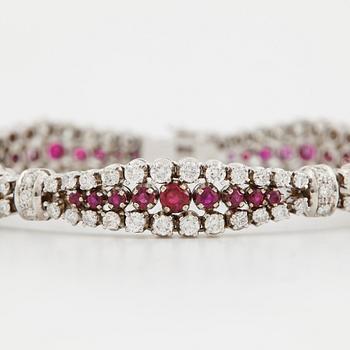 An 18K white gold bracelet set with rubies and round brilliant-cut diamonds.