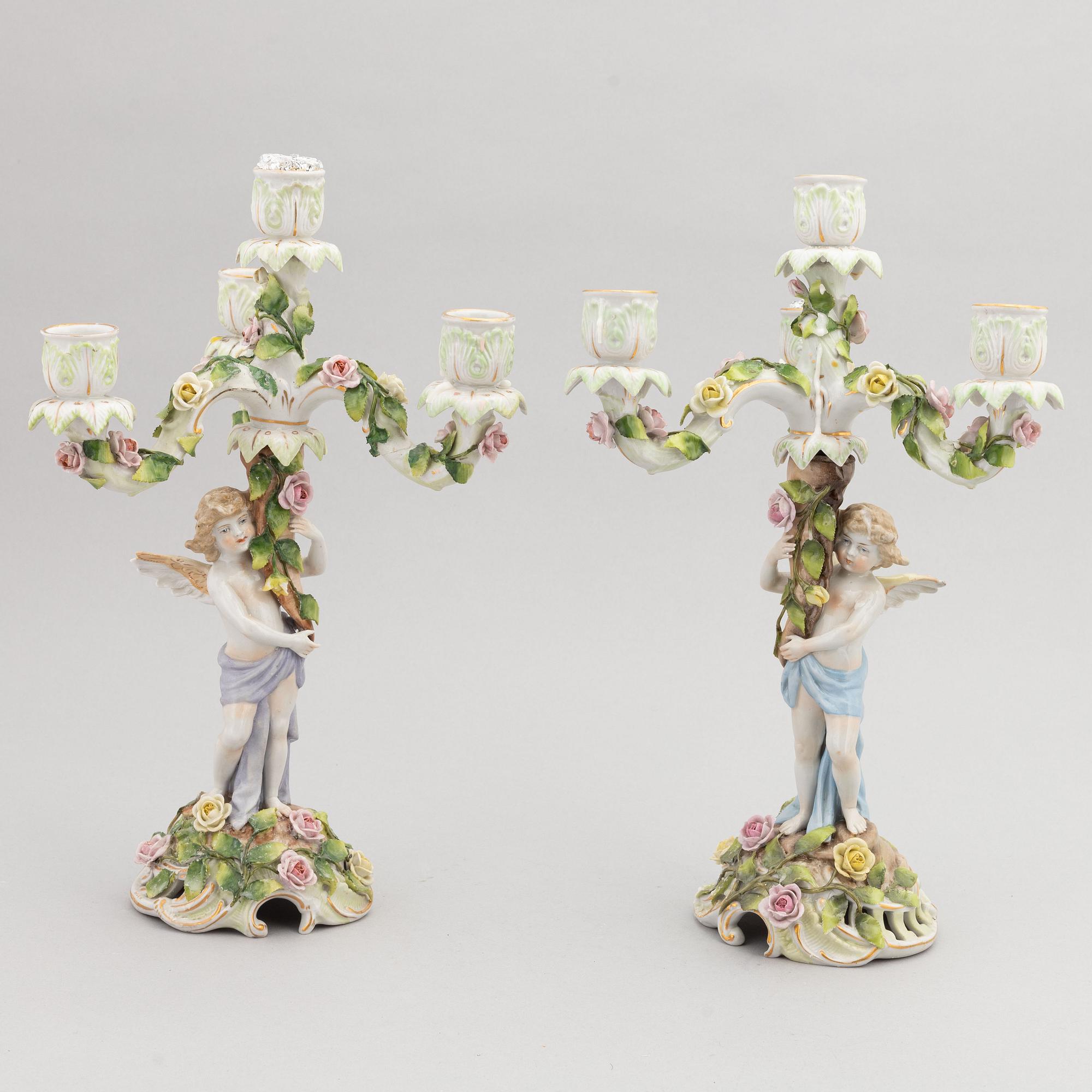 A pair of porcelain rococo style candelabra and a centerpiece bowl, Plaue, Germany, first half of the 20th century.