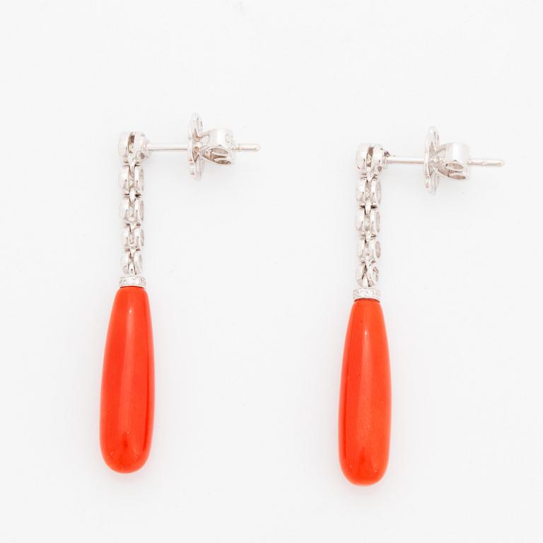 A pair of 18K gold and coral earrings set with round brilliant-cut diamonds.