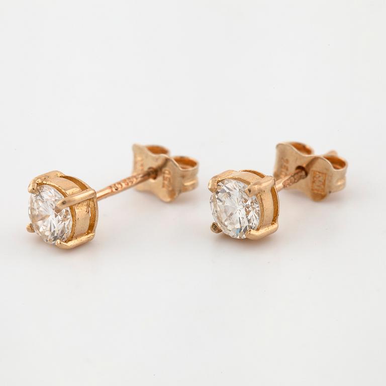 A pair of brilliant cut diamond earrings.