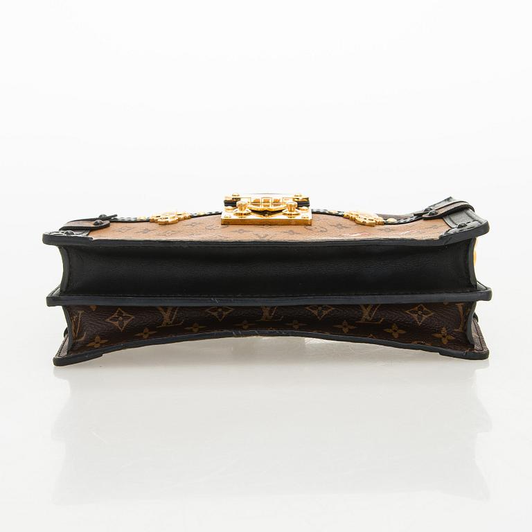 Louis Vuitton, a "Reverse Monogram Trunk Clutch" bag.