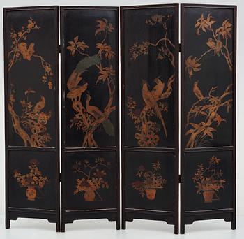 A four panel wooden and lacquered screen with inlays of stone and bone, late Qing dynasty (1912-1644).