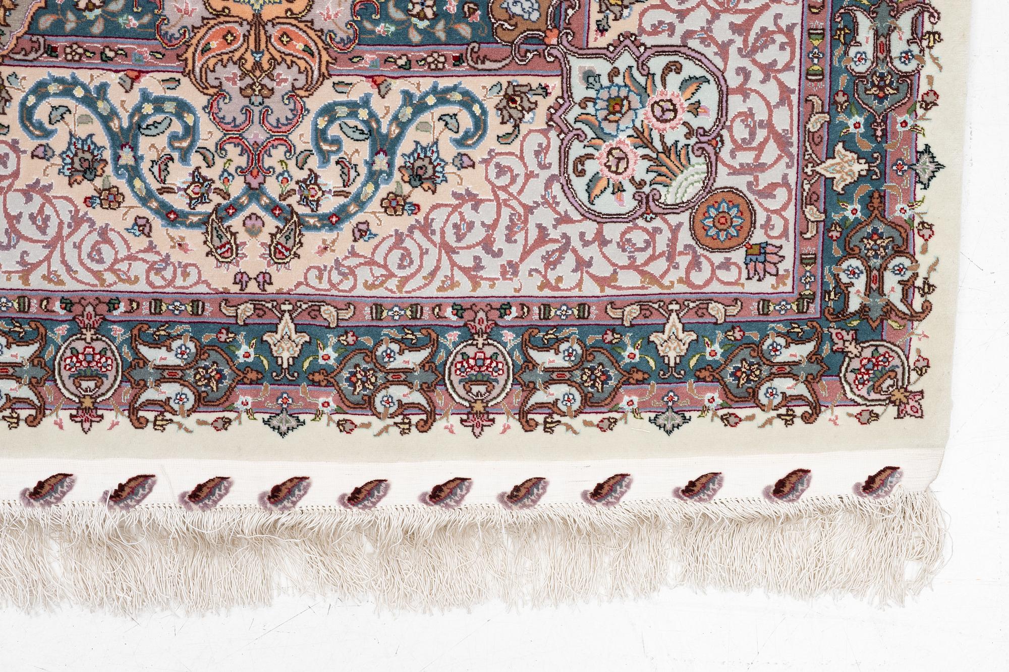 A Tabriz carpet, 210 x 195 cm. signed.