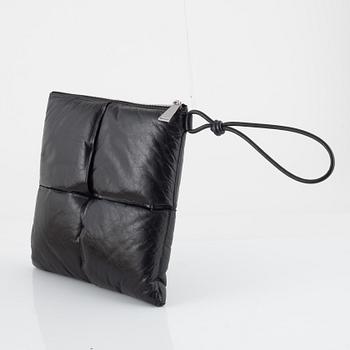 Bottega Veneta, a black leather handbag.