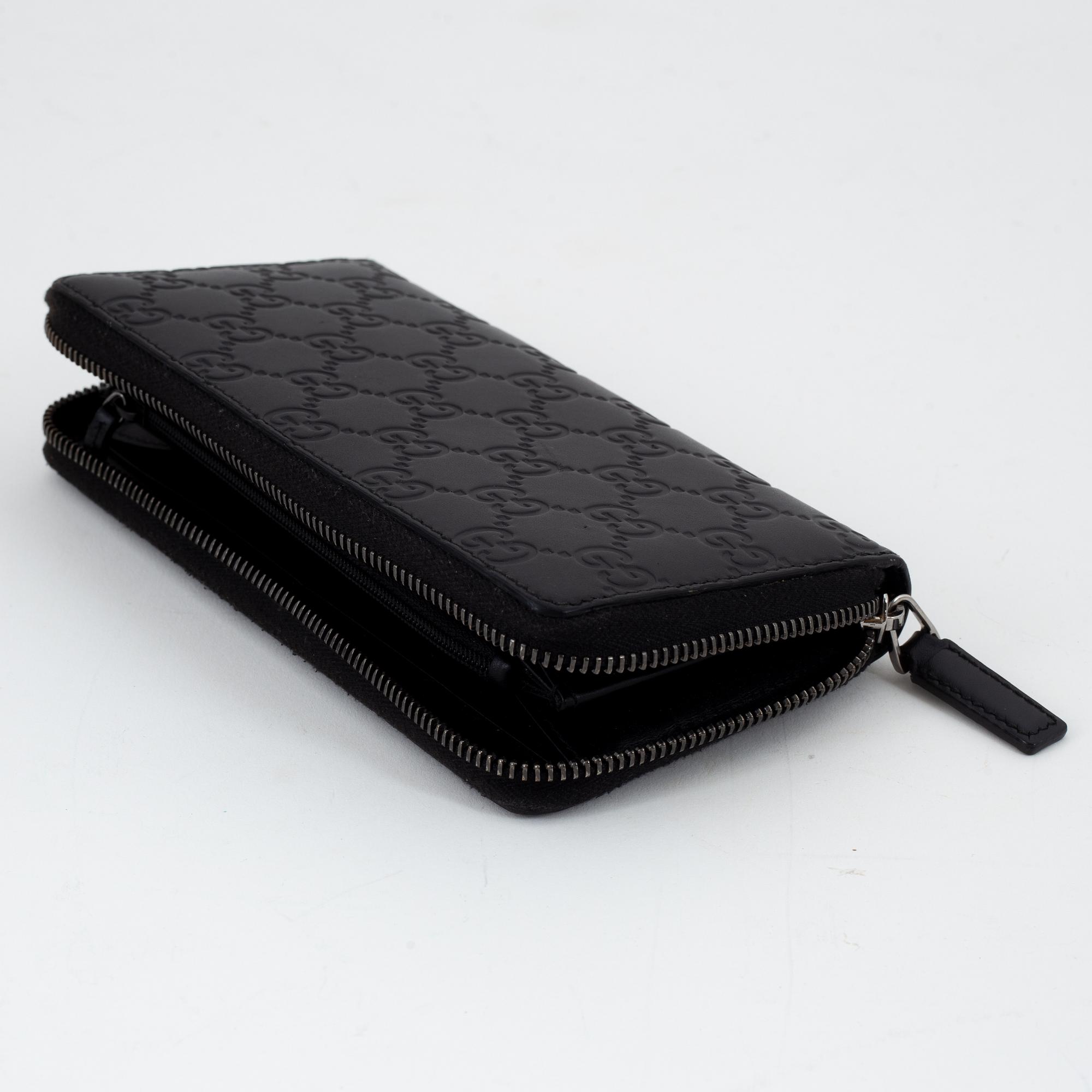 Gucci, an embossed böack leather wallet.