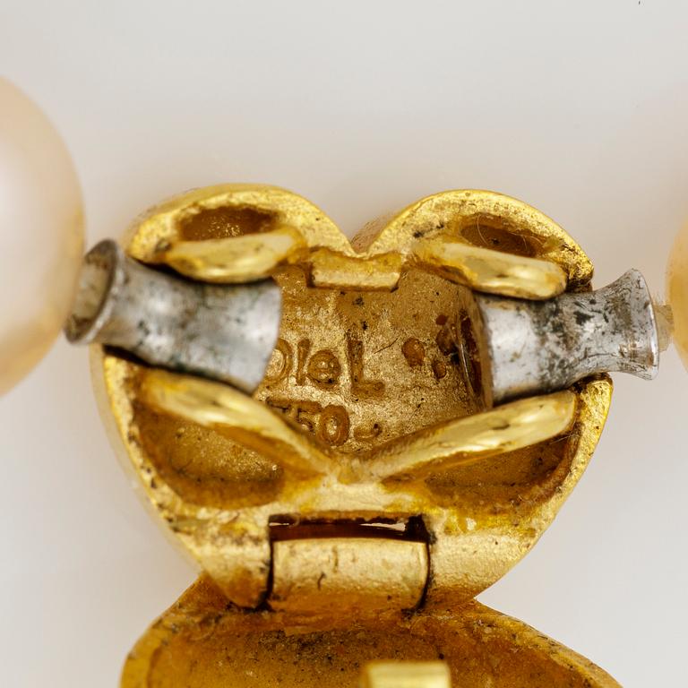 Ole Lynggaard clasp in 18K gold with a round brilliant-cut diamond and a necklace of cultured freshwater pearls.