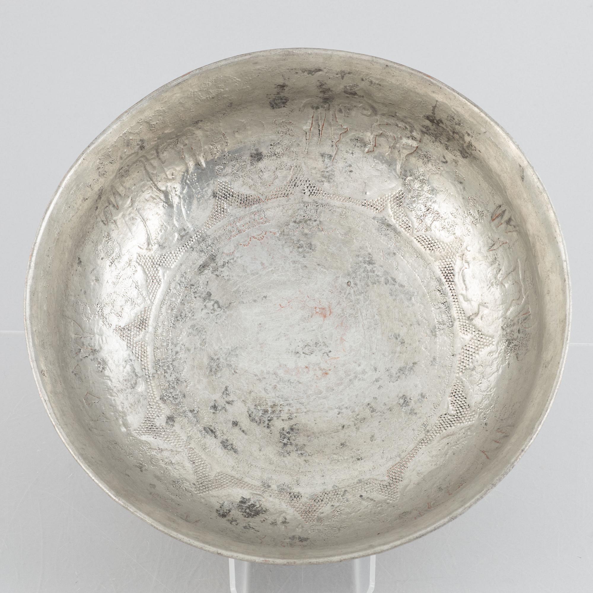 A west Asian repoussé silver and copper vessle, circa 1900.