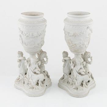 A pair of biscuit porcelain urns, owner's monogram of Oscar II of Sweden, mid 19th century.