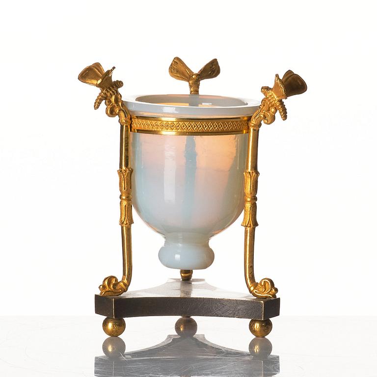 An Empire tripod with an opalin glass bowl, first part of the 19th century.