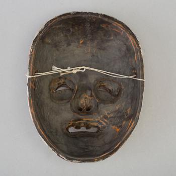 A Japanese wooden mask, 20th century.