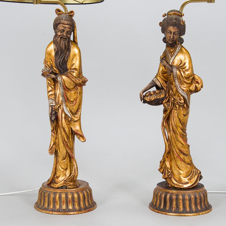 A pair of table lamps with Asian figures, later half of 20th century.