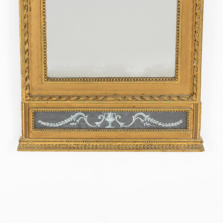 A late Gustavian giltwood and inset gouache mirror, circa 1800.