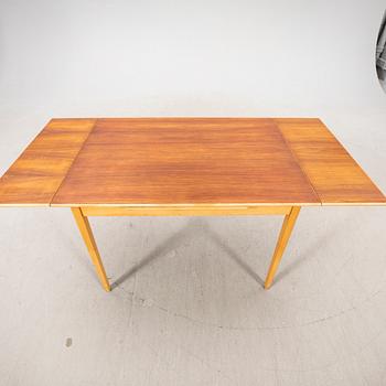 A 1960s teak and beech dining table.
